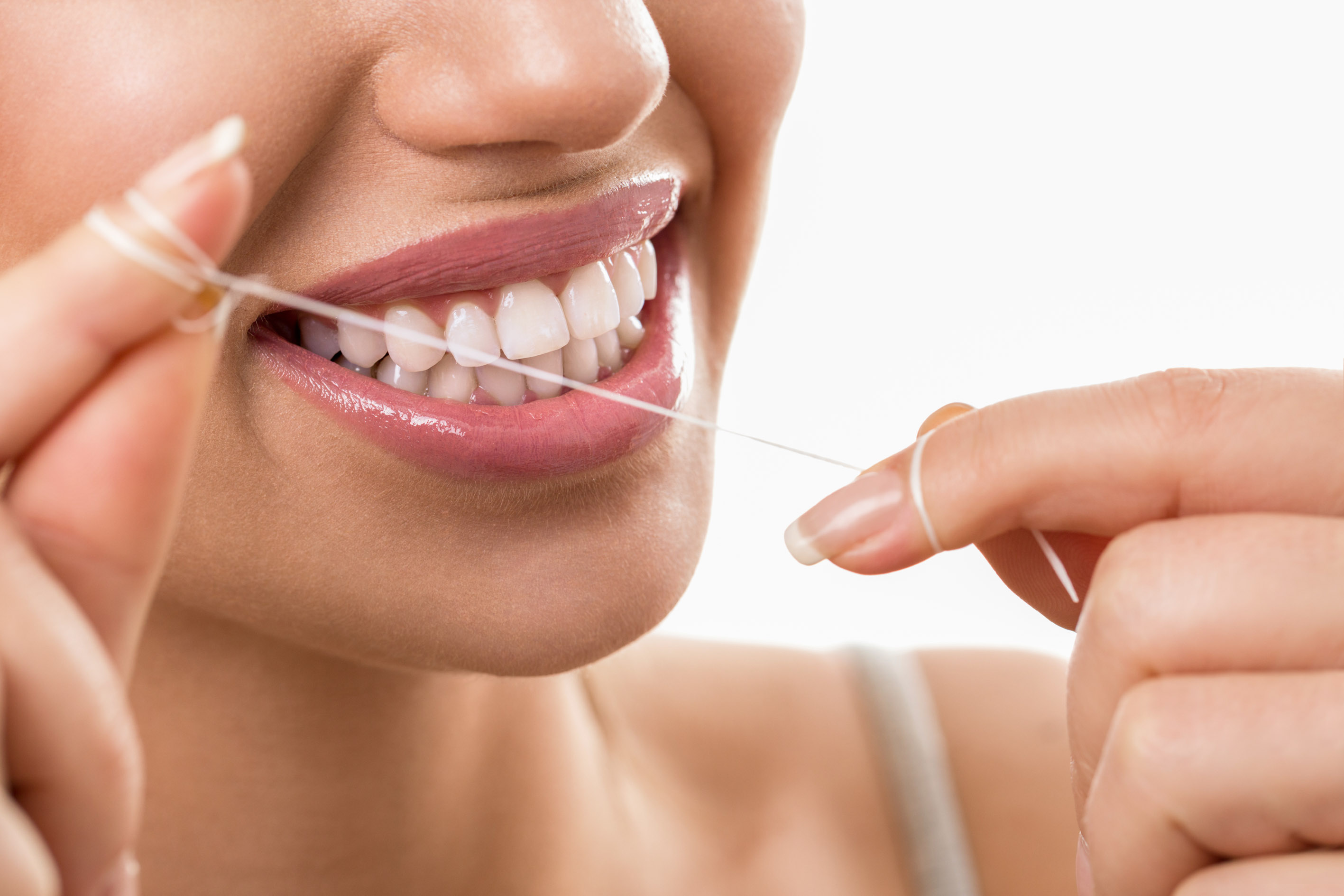 Cleaning teeth with dental floss, perfect healthy tooth